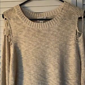 Beige sweater with cut out design on shoulder